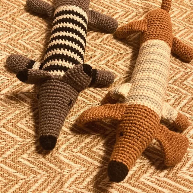 Two crocheted striped dachshunds